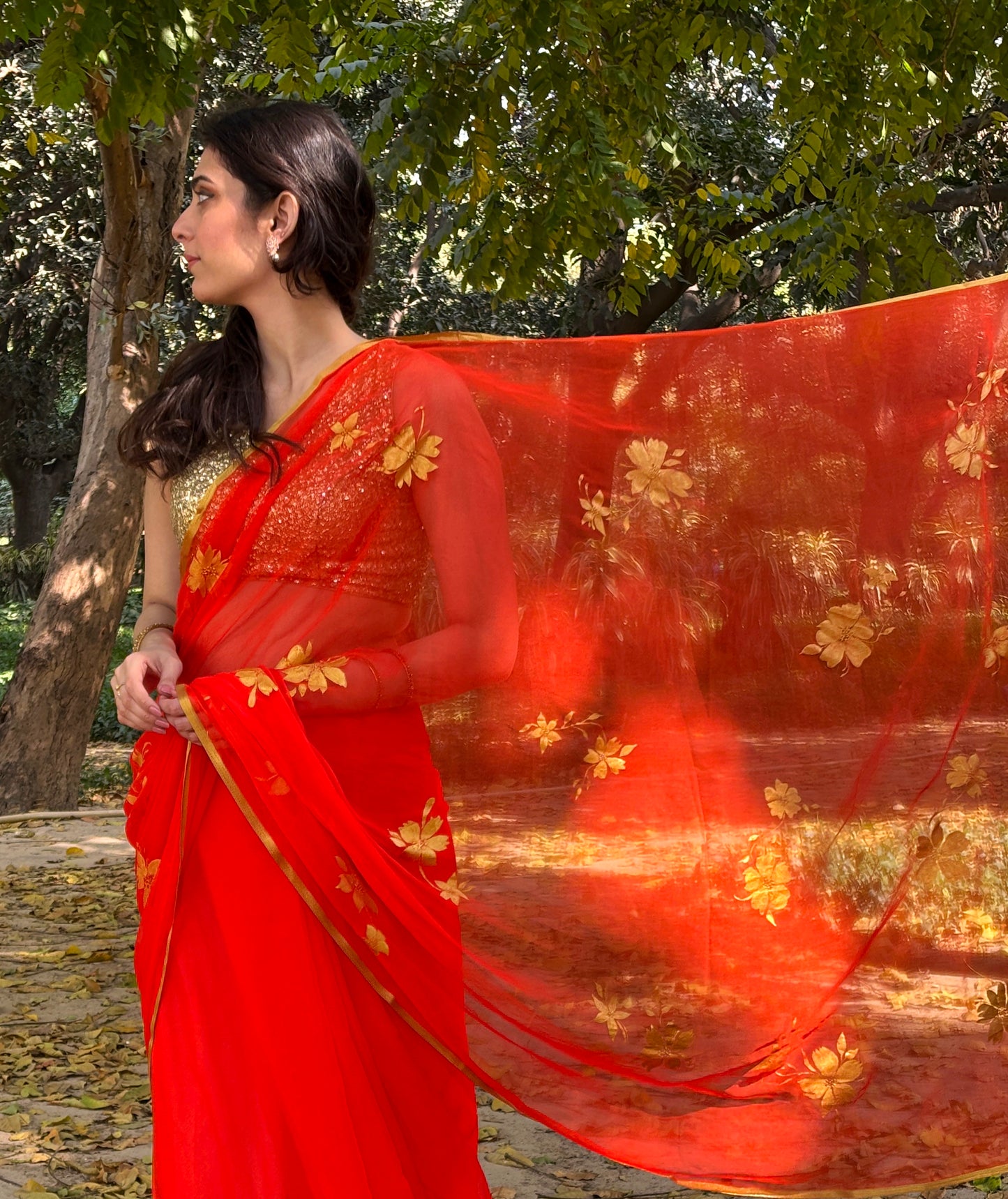 Malook orange Chiffon saree with Hand-Painted Golden floral motifs 